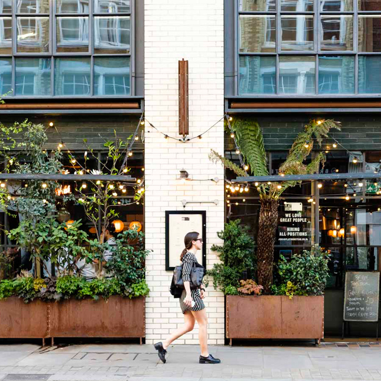 Photograph of a person walking past a building in Shoreditch