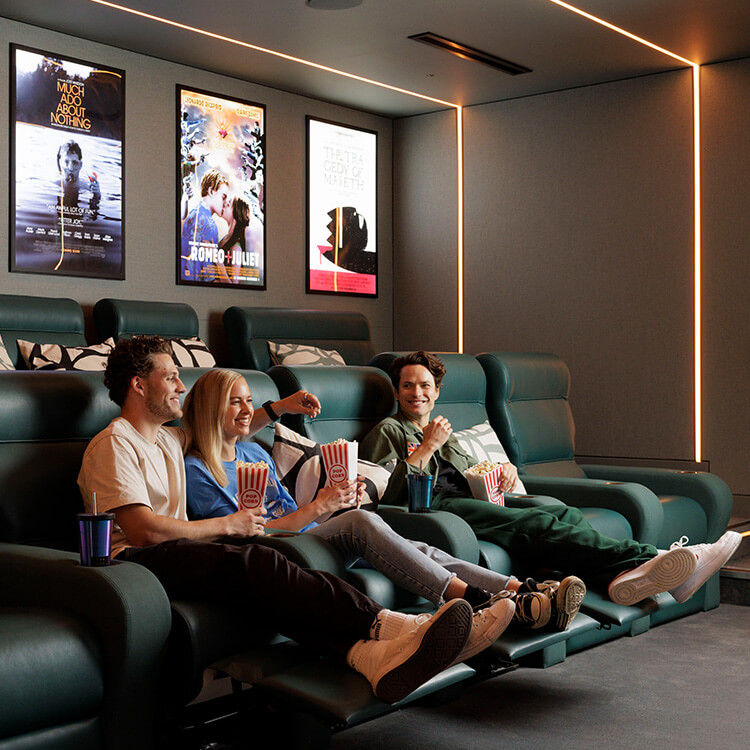Residents watching a film in the cinema at The Stage, Shoreditch Apartments