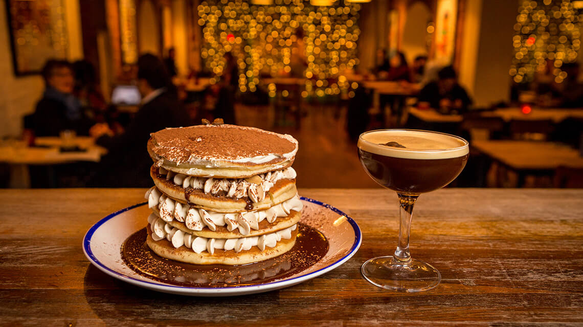 A delicious stack of espresso martini pancakes and an accompanying cocktail.